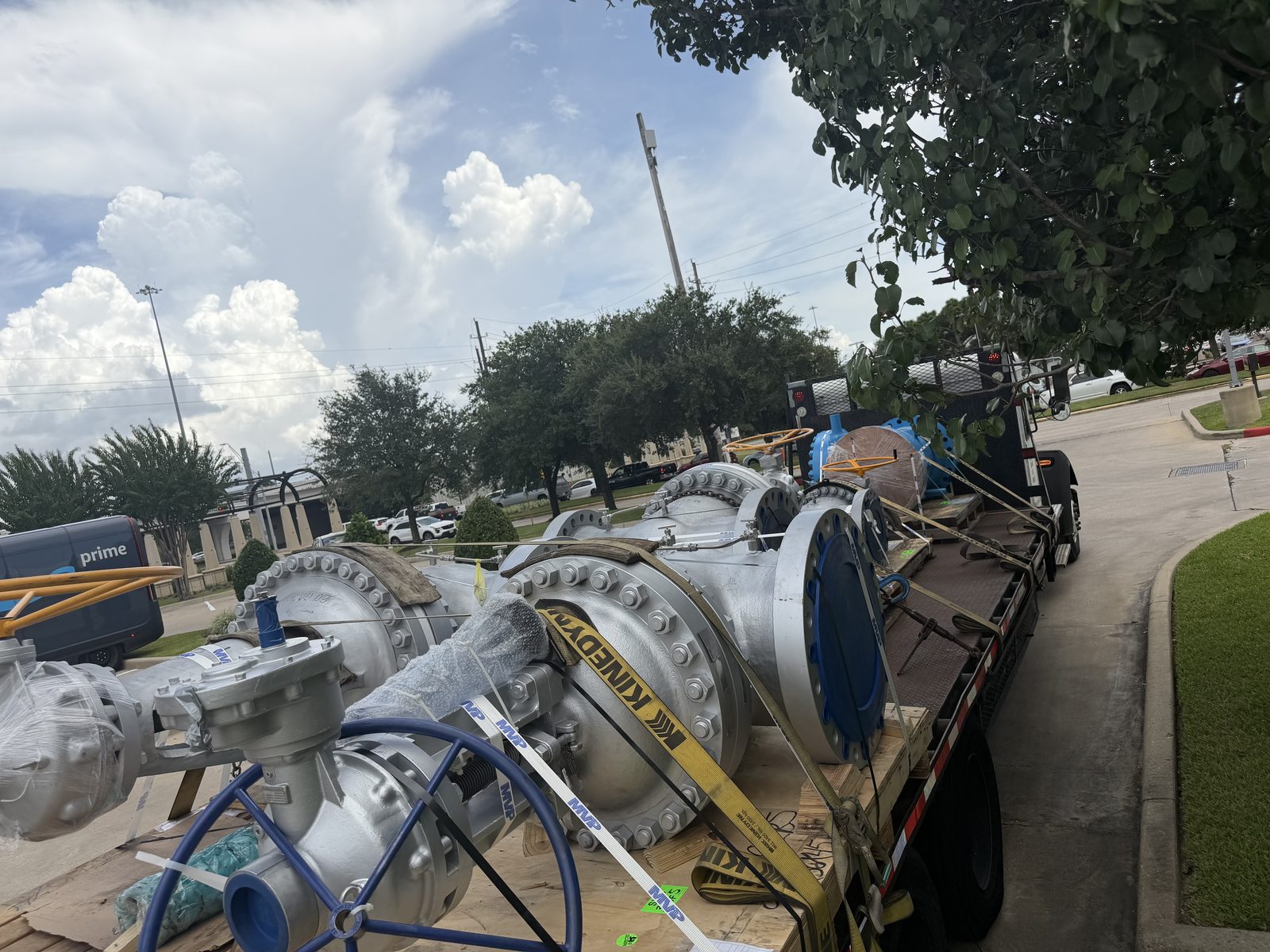 Large flanged valves strapped down on a flatbed trailer