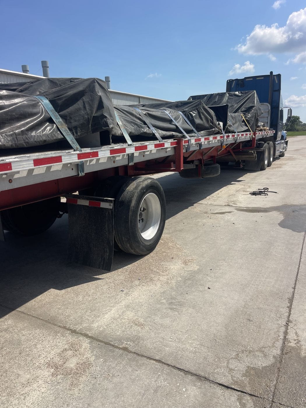 Flatbed trailer loaded with long steel beams