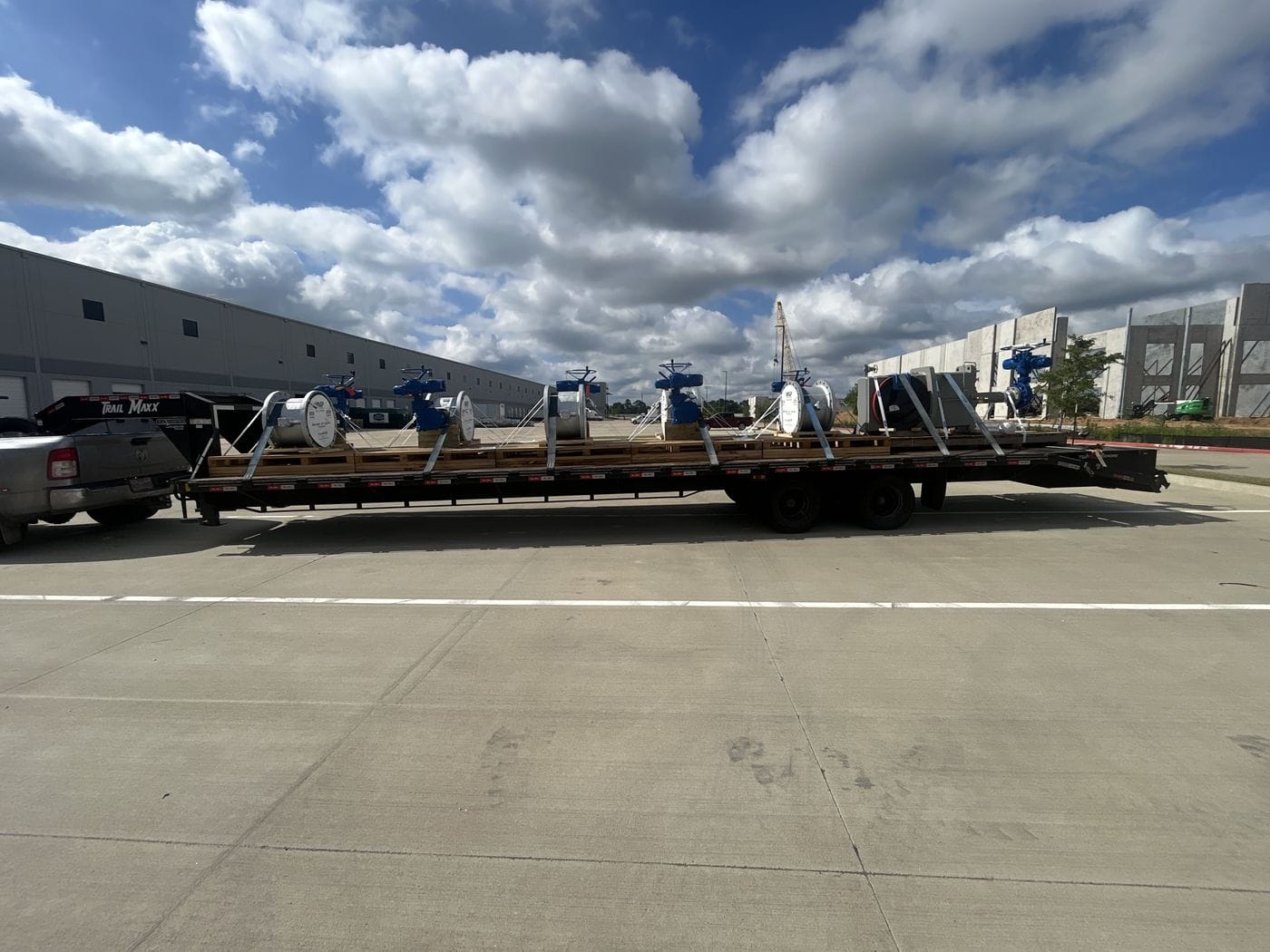 Flatbed truck hauling freight under a cloudy sky