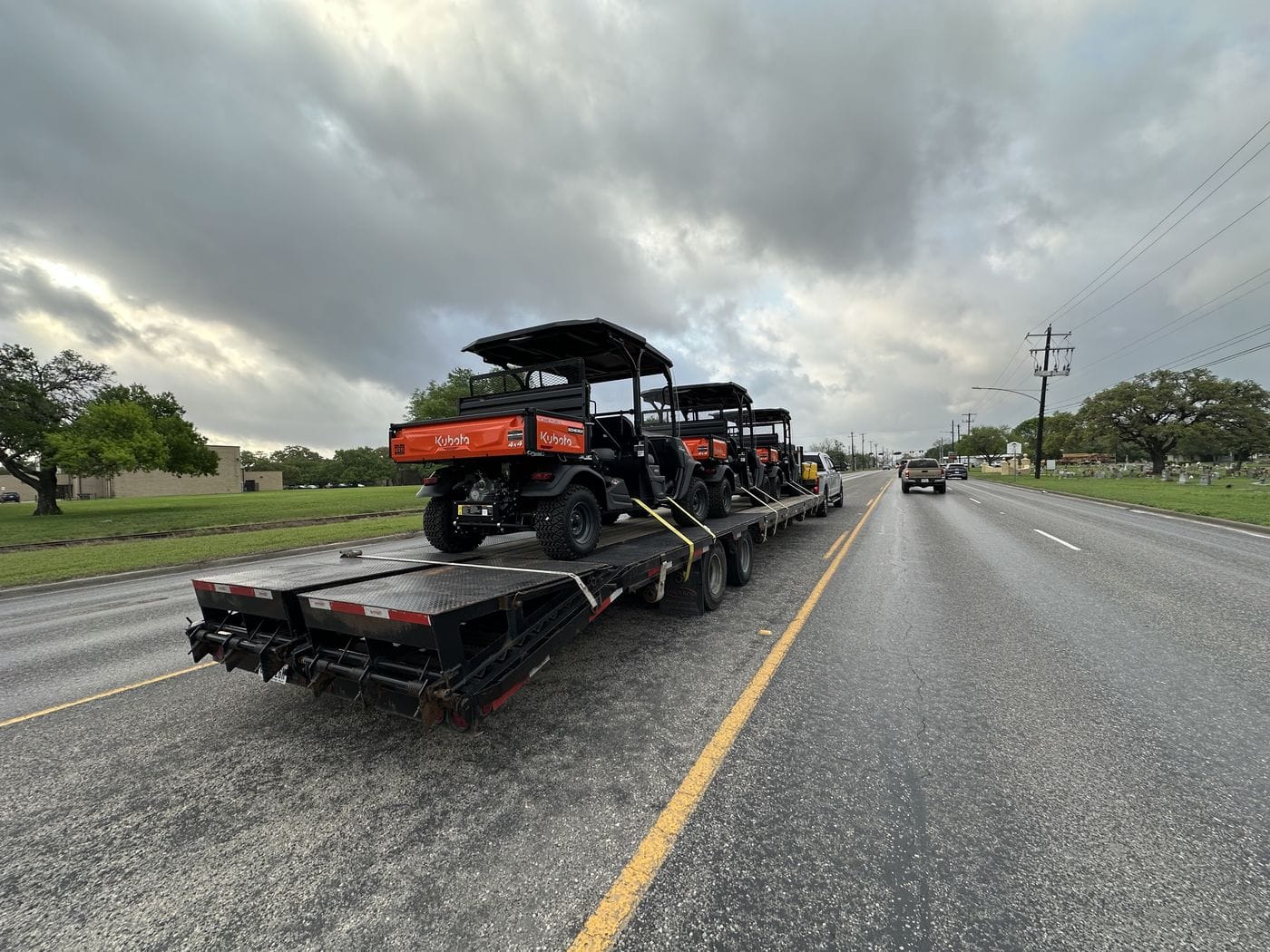 Flatbed trailer hauling equipment on the highway