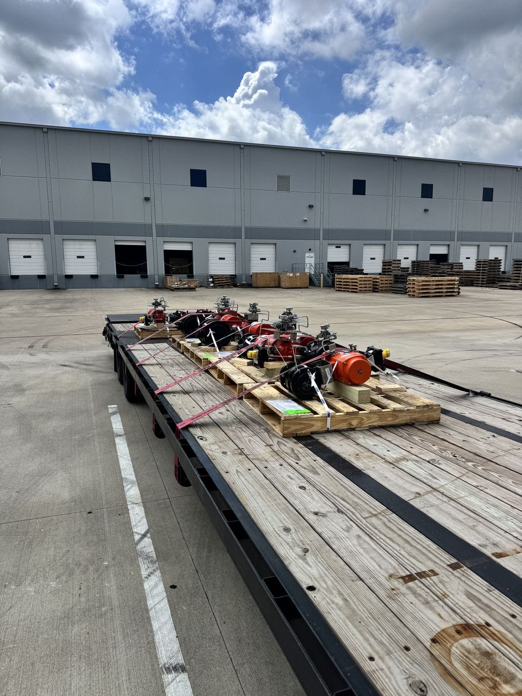 Flatbed trailer loaded with freight at a warehouse dock