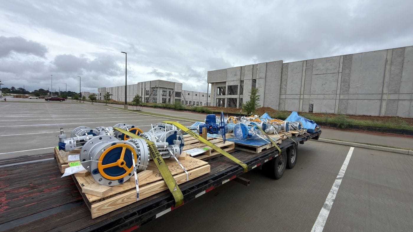 Flatbed trailers lined up at a warehouse loading dock